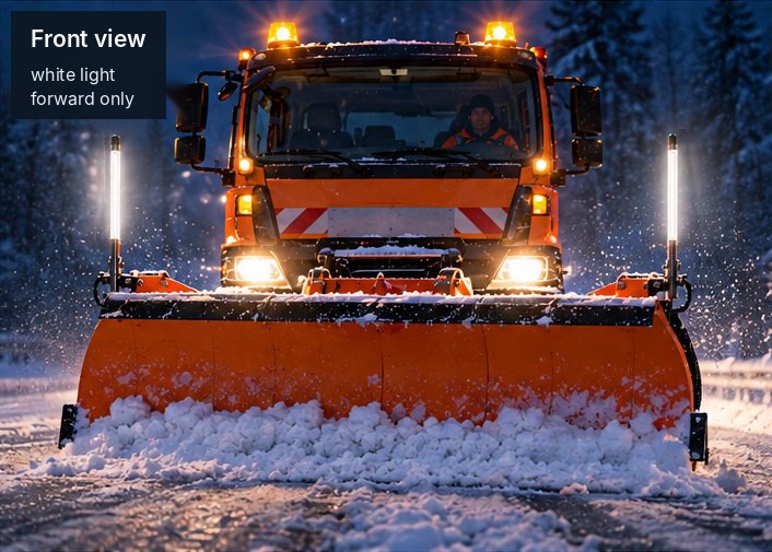 Winter maintenance vehicle from the front at night: light rods at both ends of the snow plough shine white to the front